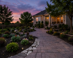 Paver walkway through a landscaped front yard