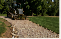 Gravel driveway installation beside a lawn